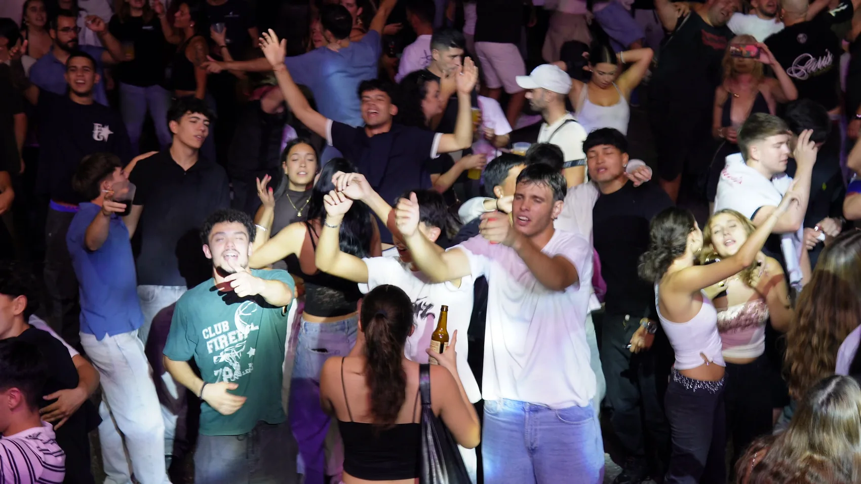 Crowd at an IWARO performance beneath stage lights